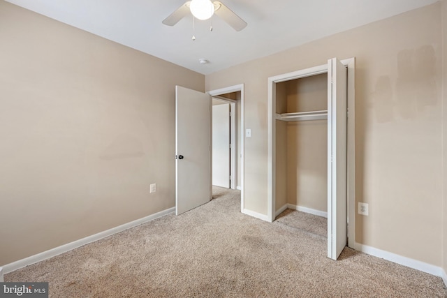 unfurnished bedroom featuring light carpet, a closet, and ceiling fan