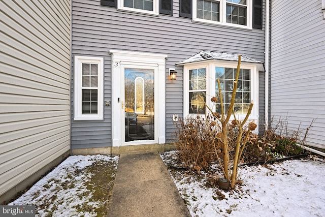 view of snow covered property entrance