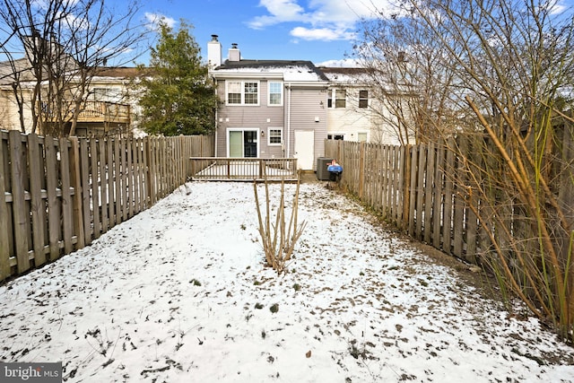 yard covered in snow with central air condition unit