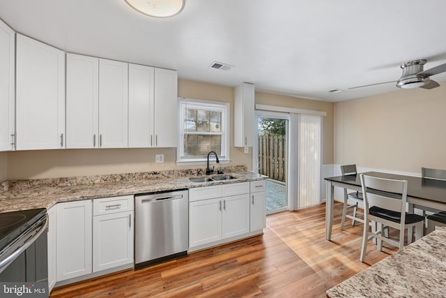 kitchen featuring white cabinets, sink, light hardwood / wood-style flooring, ceiling fan, and stainless steel appliances