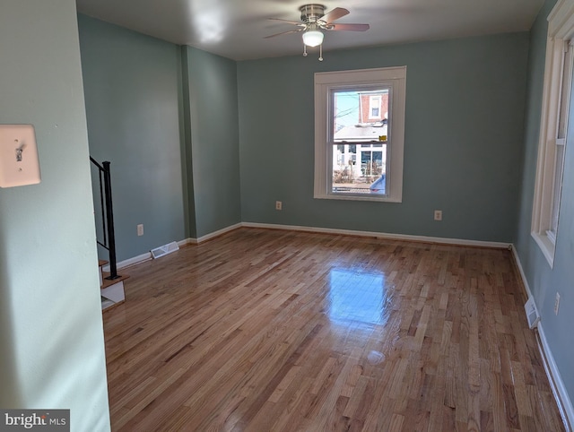 empty room featuring ceiling fan and light hardwood / wood-style floors