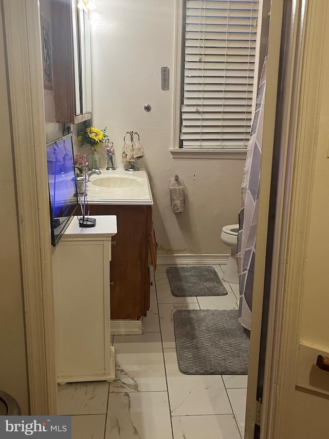 bathroom featuring toilet and vanity