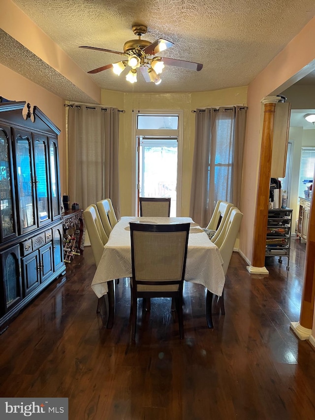 dining area featuring dark hardwood / wood-style flooring, ceiling fan, and a textured ceiling