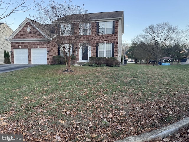 view of front of house with a garage and a front yard