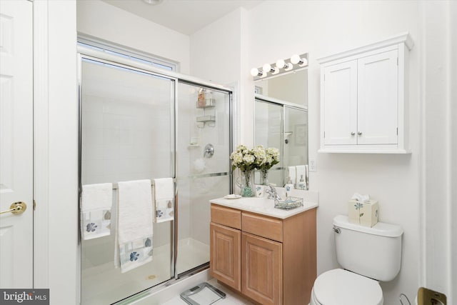 bathroom featuring toilet, walk in shower, and vanity