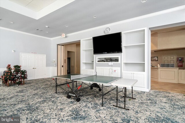 recreation room featuring built in features and ornamental molding