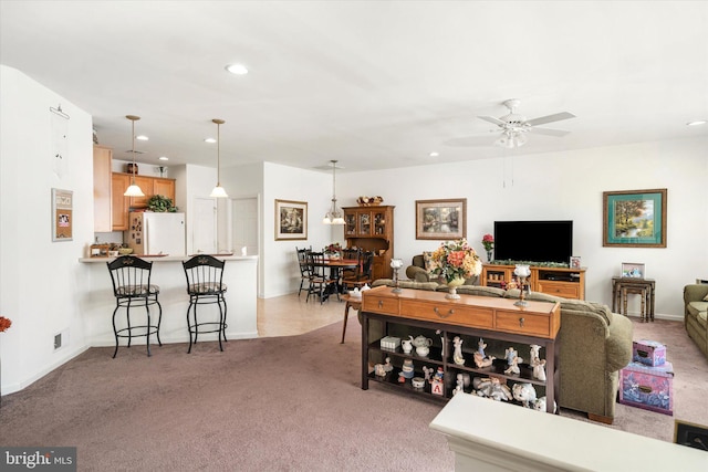 living room with light carpet and ceiling fan