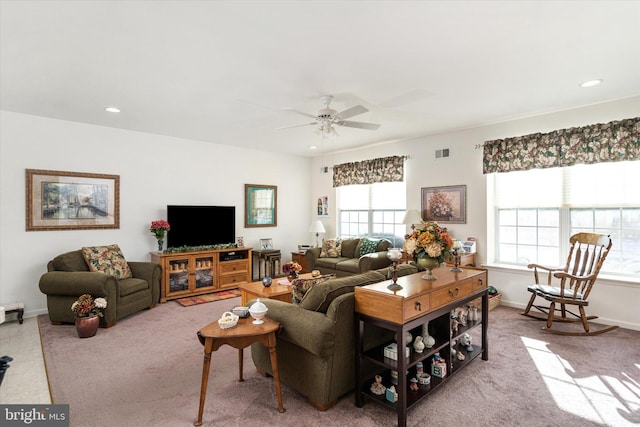 carpeted living room with ceiling fan and plenty of natural light