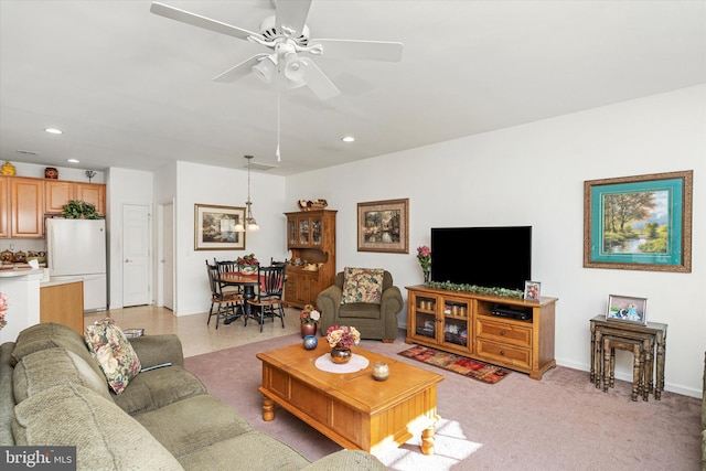 carpeted living room featuring ceiling fan