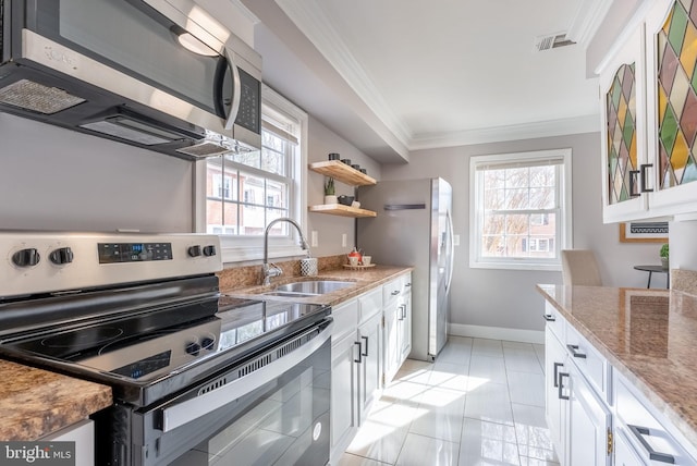 kitchen with sink, white cabinetry, crown molding, appliances with stainless steel finishes, and light stone countertops