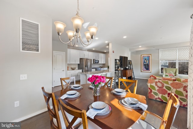 dining room featuring dark hardwood / wood-style flooring and a notable chandelier