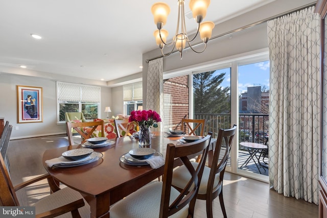 dining space featuring plenty of natural light, a chandelier, and dark hardwood / wood-style flooring