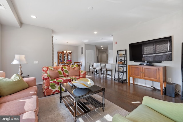 living room featuring dark hardwood / wood-style floors and a chandelier