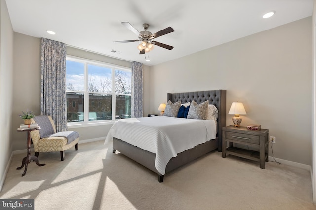 bedroom featuring light colored carpet and ceiling fan