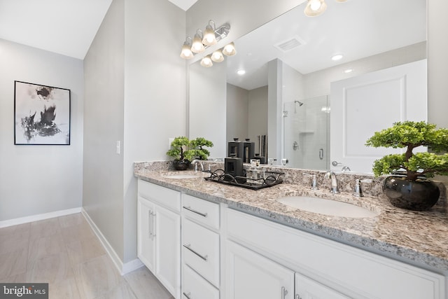 bathroom featuring vanity and a shower with shower door