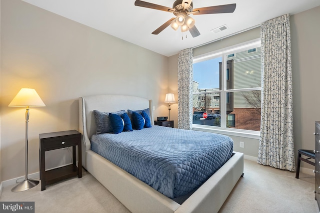 bedroom with light colored carpet and ceiling fan