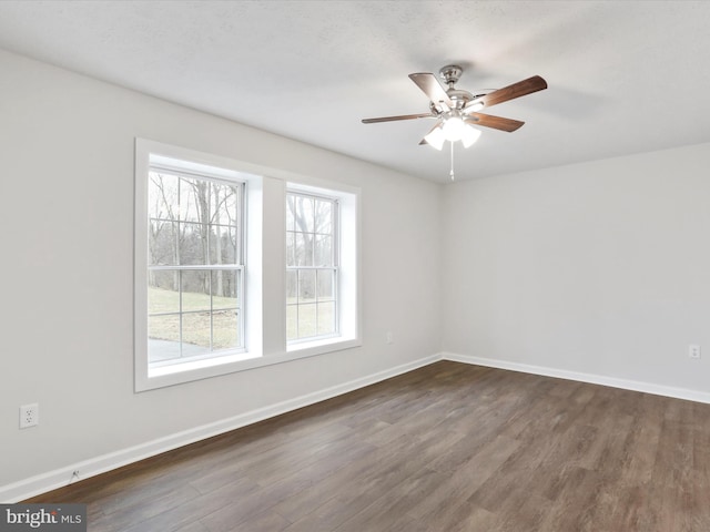 unfurnished room featuring ceiling fan and dark hardwood / wood-style floors