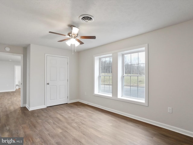 unfurnished bedroom with hardwood / wood-style floors and ceiling fan