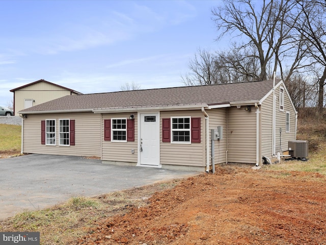 ranch-style house with central air condition unit and a patio area