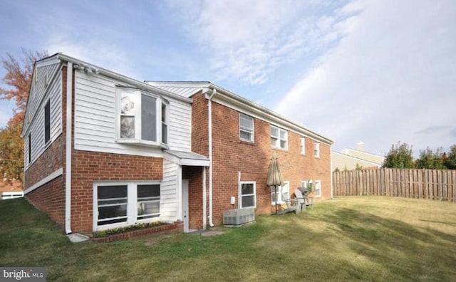 rear view of house featuring a yard