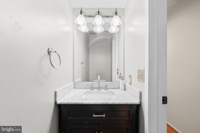 bathroom featuring a textured ceiling and vanity