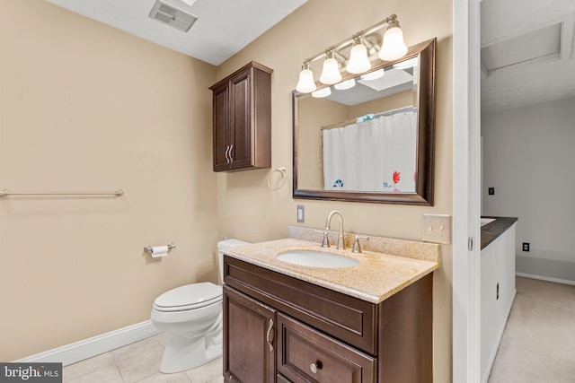 bathroom featuring toilet, tile patterned flooring, and vanity