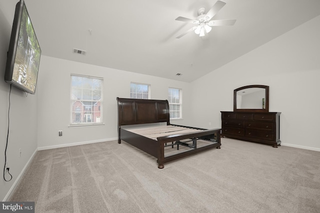 bedroom with ceiling fan, light colored carpet, and lofted ceiling