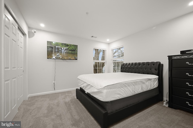 bedroom with carpet flooring and a closet