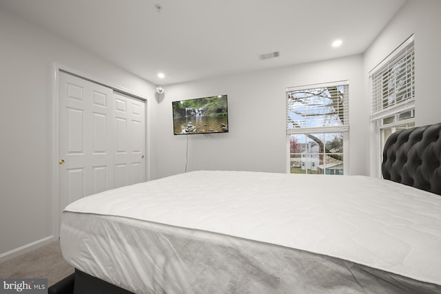 carpeted bedroom with a closet