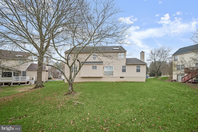 back of house featuring a lawn