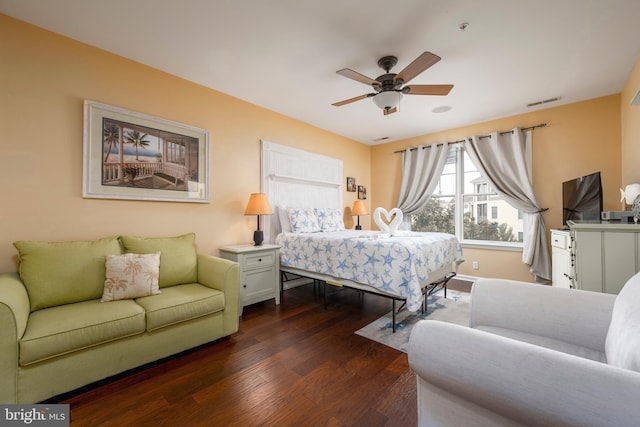 bedroom with ceiling fan and dark wood-type flooring