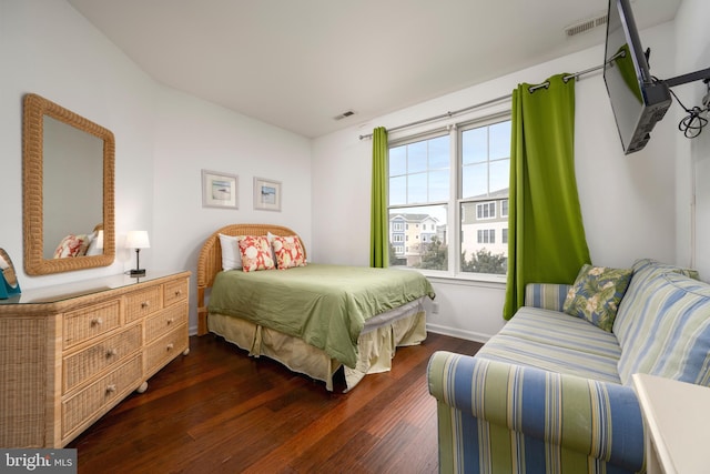 bedroom with dark hardwood / wood-style floors