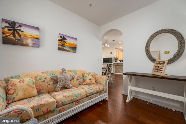 living room with a chandelier and wood-type flooring