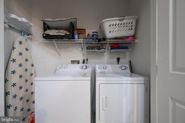 clothes washing area featuring washer and dryer