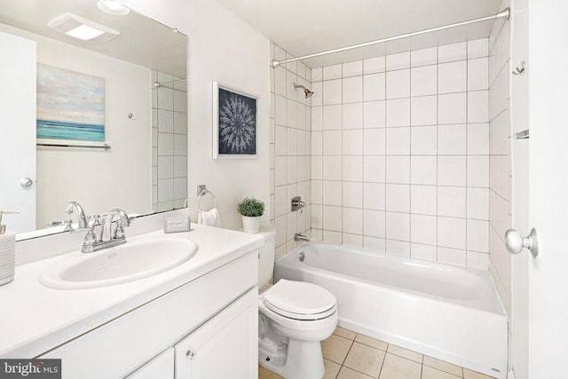 full bathroom featuring tile patterned flooring, vanity, toilet, and tiled shower / bath