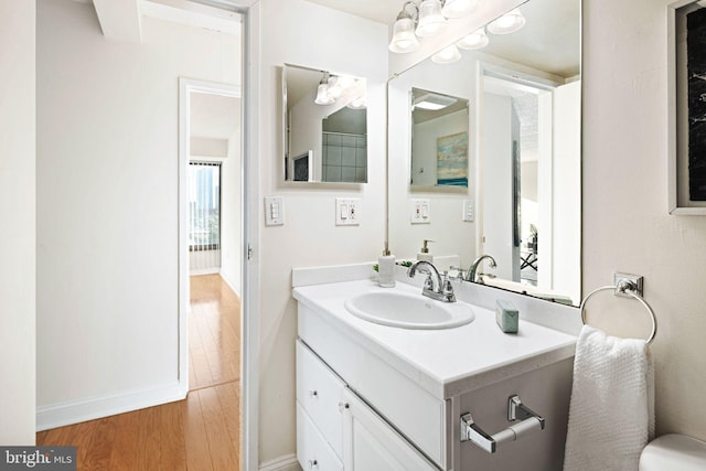 bathroom with hardwood / wood-style floors and vanity