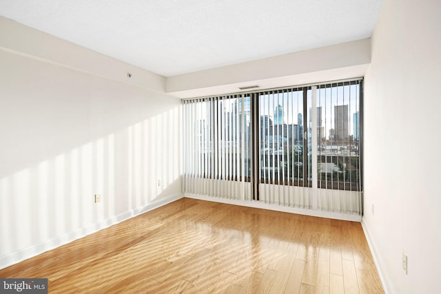 spare room with wood-type flooring