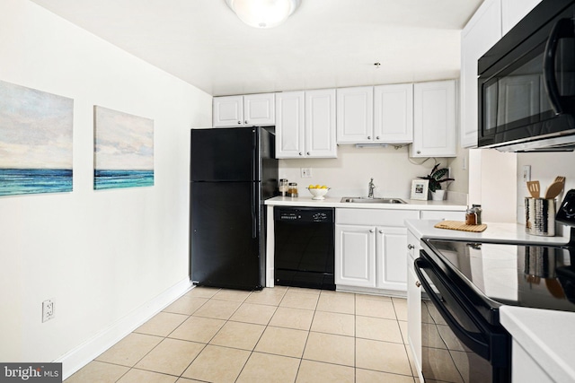 kitchen with white cabinets, sink, light tile patterned flooring, and black appliances