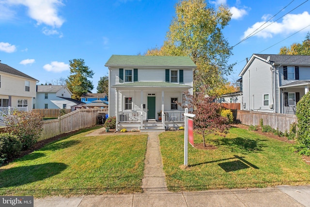 view of front of home with covered porch and a front yard