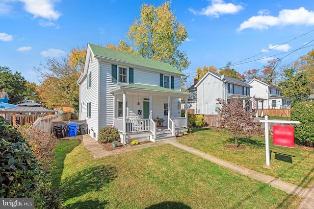 view of front of property with covered porch and a front yard