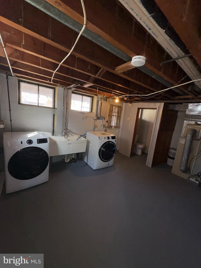 interior space with washing machine and clothes dryer and sink