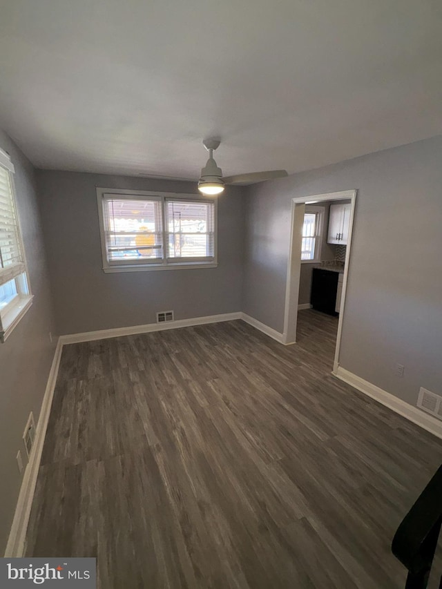 unfurnished room with dark hardwood / wood-style flooring