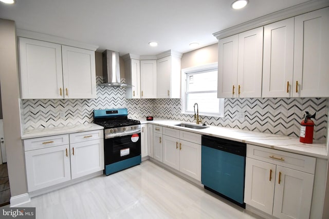 kitchen featuring appliances with stainless steel finishes, backsplash, sink, wall chimney range hood, and white cabinets