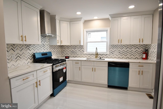 kitchen with white cabinets, wall chimney range hood, sink, decorative backsplash, and appliances with stainless steel finishes