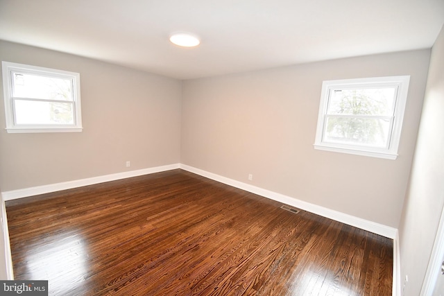 empty room featuring dark wood-type flooring