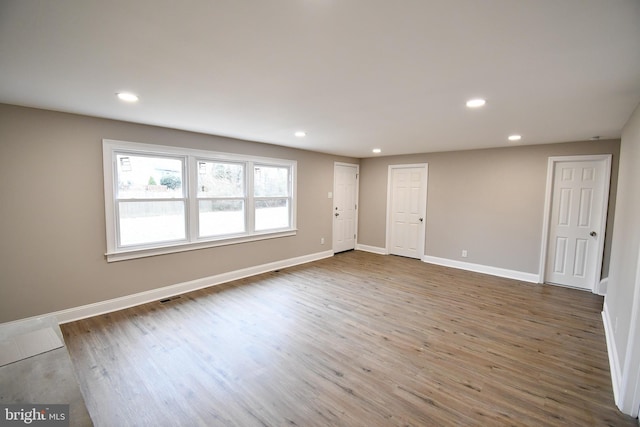 unfurnished room with wood-type flooring