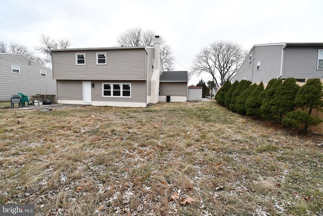 rear view of house featuring a patio and a lawn