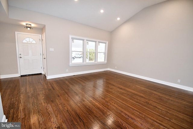 entrance foyer featuring dark wood-type flooring and lofted ceiling