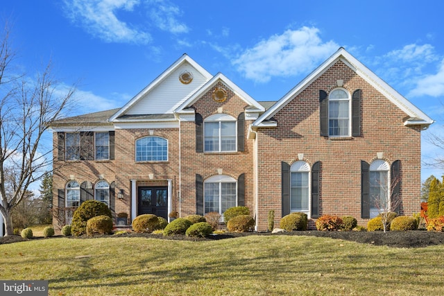 view of front of home with a front yard and french doors