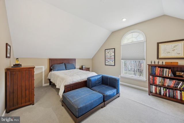 carpeted bedroom with lofted ceiling